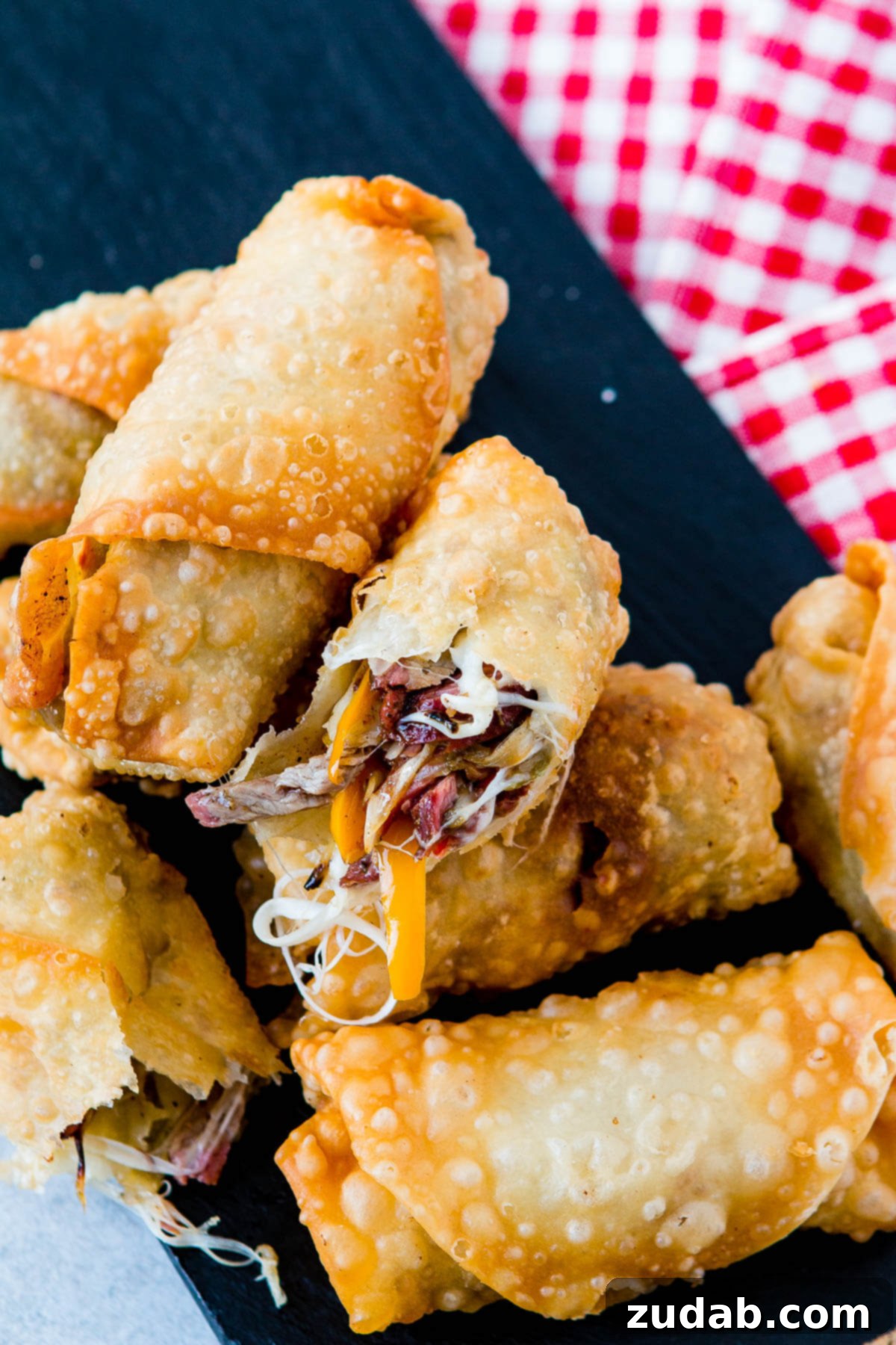 Crispy Philly Cheesesteak Egg Rolls 5 Close-up of a perfectly wrapped Philly Cheesesteak Egg Roll, ready for frying. Delicious party food!