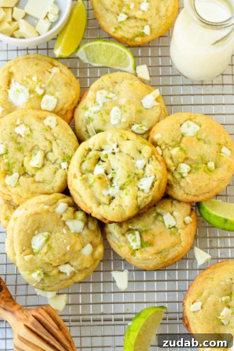 Zesty White Chocolate Key Lime Cookies 7 a photo of several perfectly golden baked cookies loaded with white chocolate chunks and lime zest