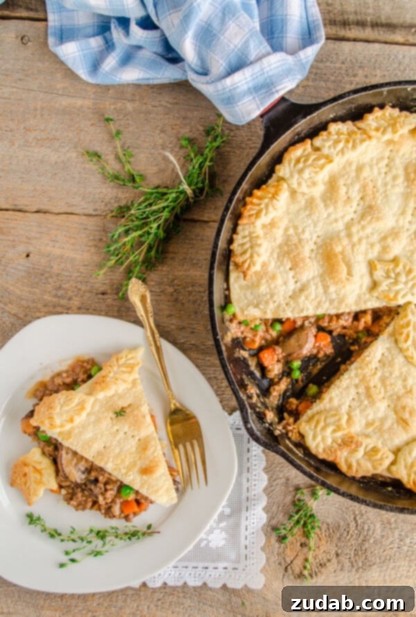 Weeknight Skillet Beef Pot Pie 3 A 30 Minute Skillet Beef Pot Pie is shown with a slice removed and sitting on a plate next to the skillet.