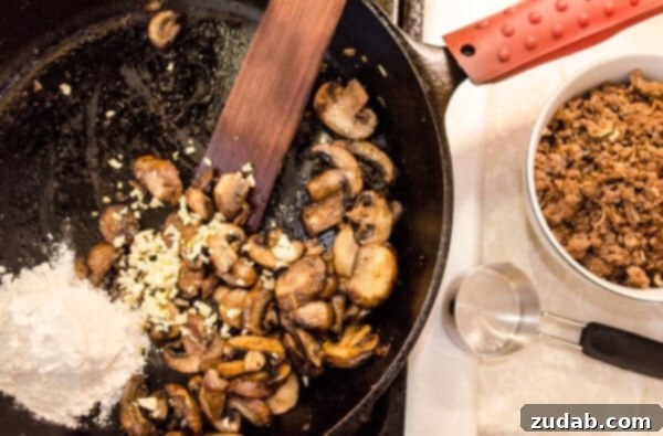 Weeknight Skillet Beef Pot Pie 4 Sliced mushrooms cook in a skillet along with minced garlic and flour for 30 Minute Skillet Beef Pot Pie recipe.