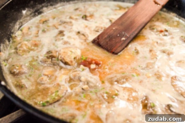 Weeknight Skillet Beef Pot Pie 6 Broth, fresh herbs and tomato paste are stirred with cooked mushrooms in a skillet for 30 Minute Skillet Beef Pot Pie recipe.