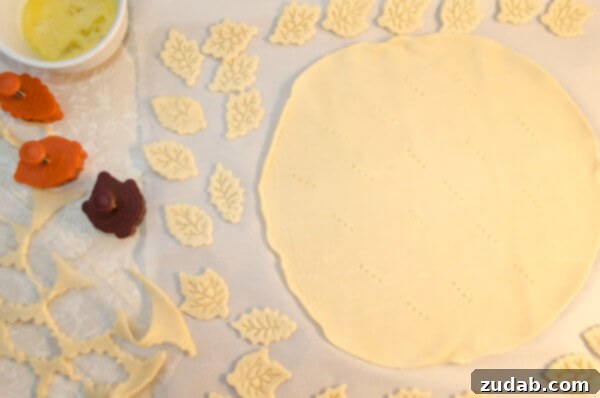 Weeknight Skillet Beef Pot Pie 7 Store bought pie crust is rolled out for 30 Minute Skillet Beef Pot Pie recipe decorated with leaf shaped cut outs.