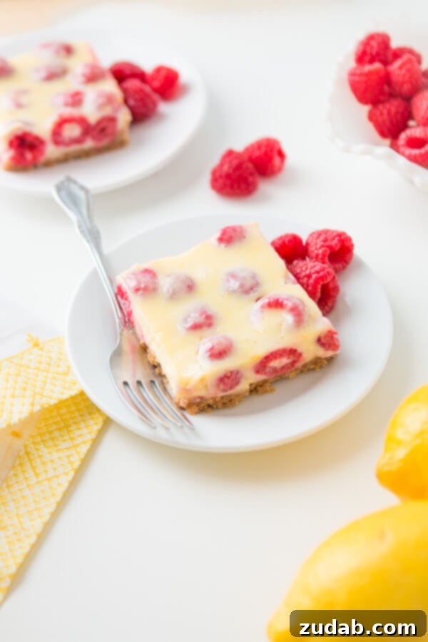 The Irresistible Layers of Lemon Raspberry Bars Lemon Raspberry Bars with a buttery graham cracker crust!