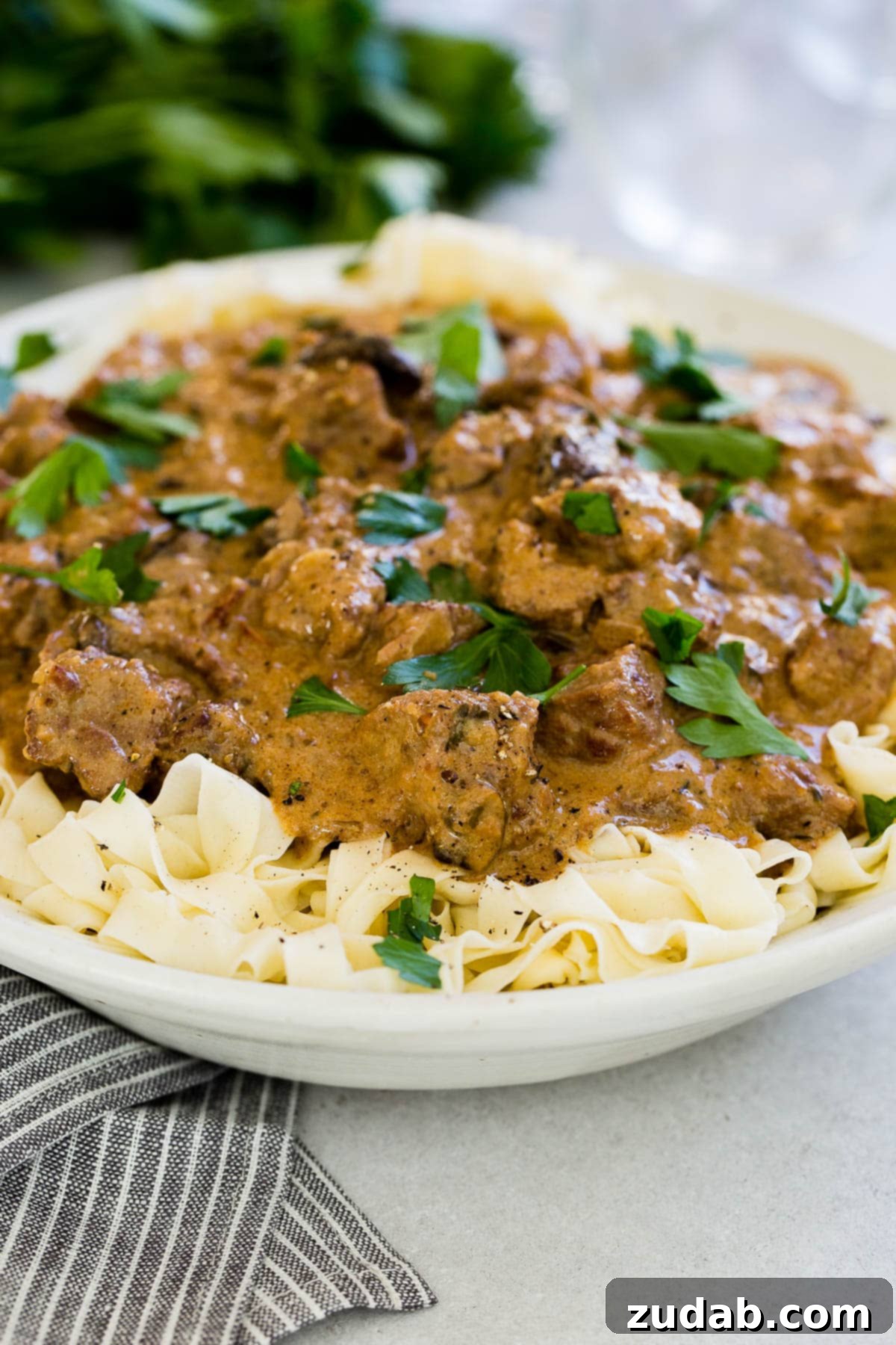 Effortless Instant Pot Beef Stroganoff 2 instant pot beef stroganoff atop noodles in white bowl