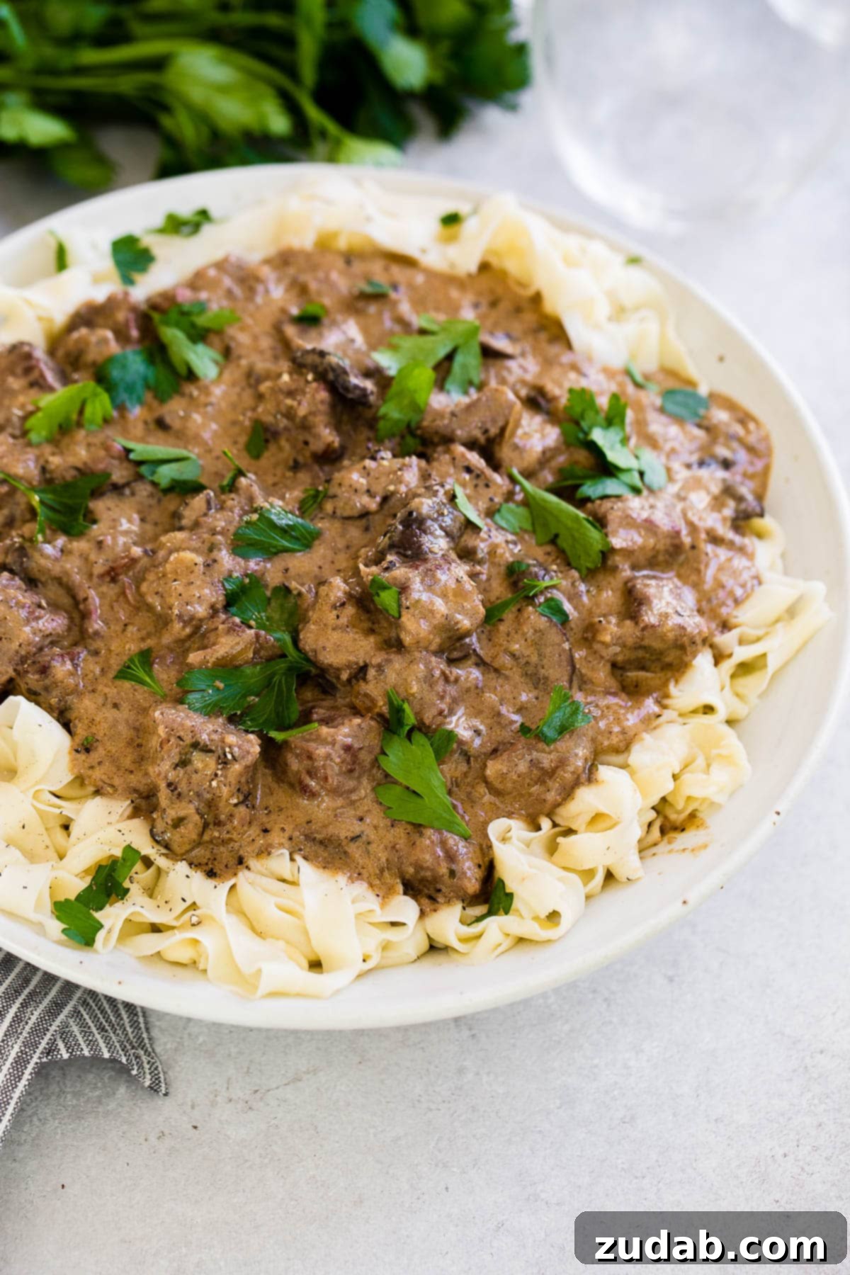 Effortless Instant Pot Beef Stroganoff 3 bowl of noodles topped with instant pot beef stroganoff