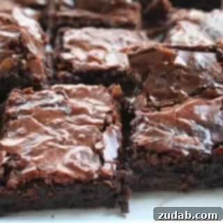 Deliciously rich Ina Garten's Outrageous Brownies, cut into perfect squares.