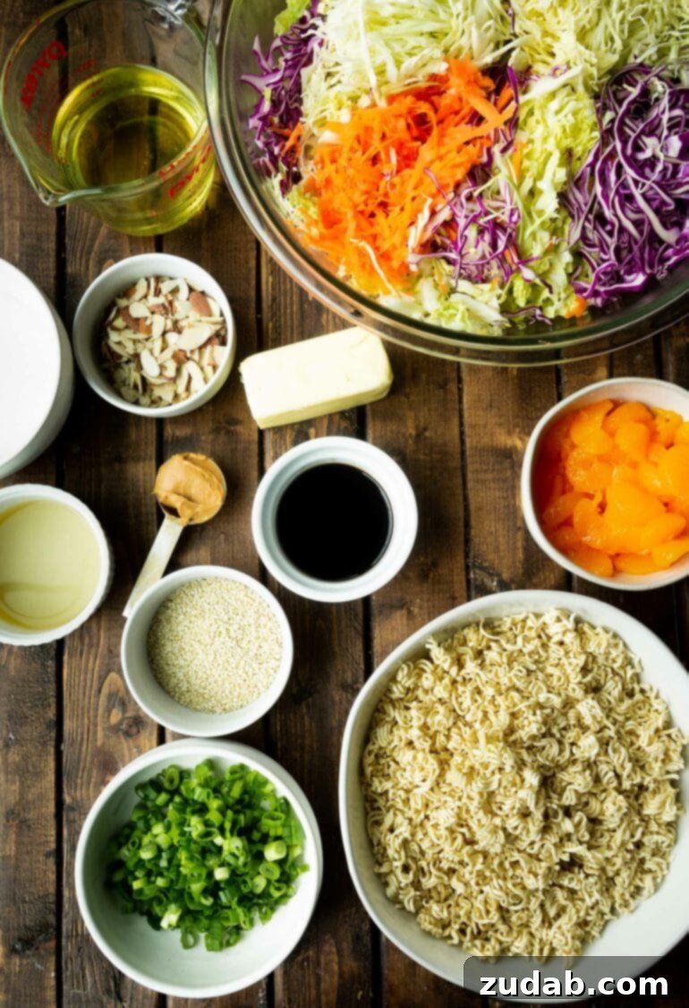 a photo taken above several bowls containing all the ingredients for oriental chicken salad with ramen noodles.