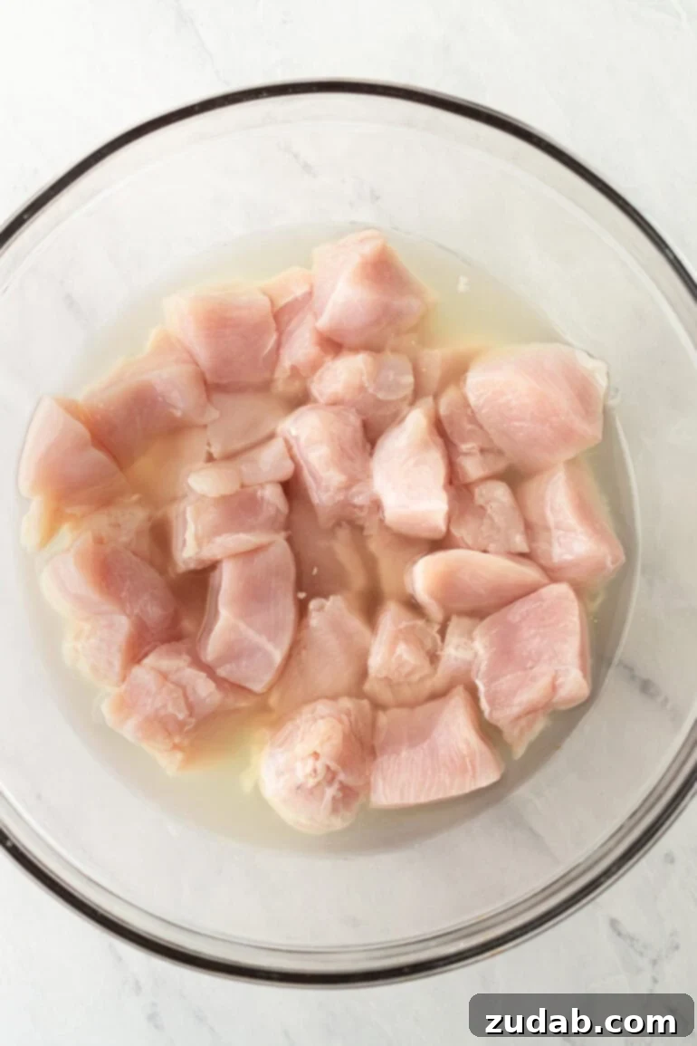 Raw chicken brining in pickle juice