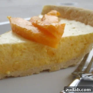 Sunshine Mango Cloud 3 Close-up of a slice of Mango Chiffon Pie with a flaky crust.