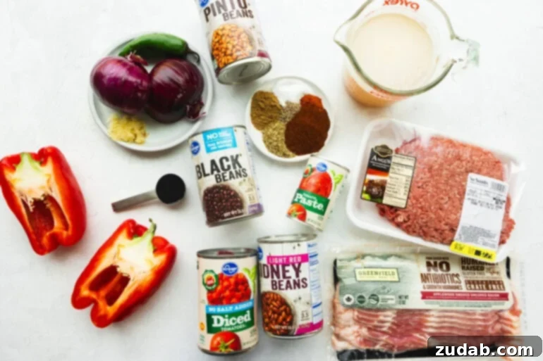 all the ingredients for the best instant pot chili with ground beef, bacon, black beans, pinto beans, fire roasted tomatoes, onions, red bell pepper, and spices