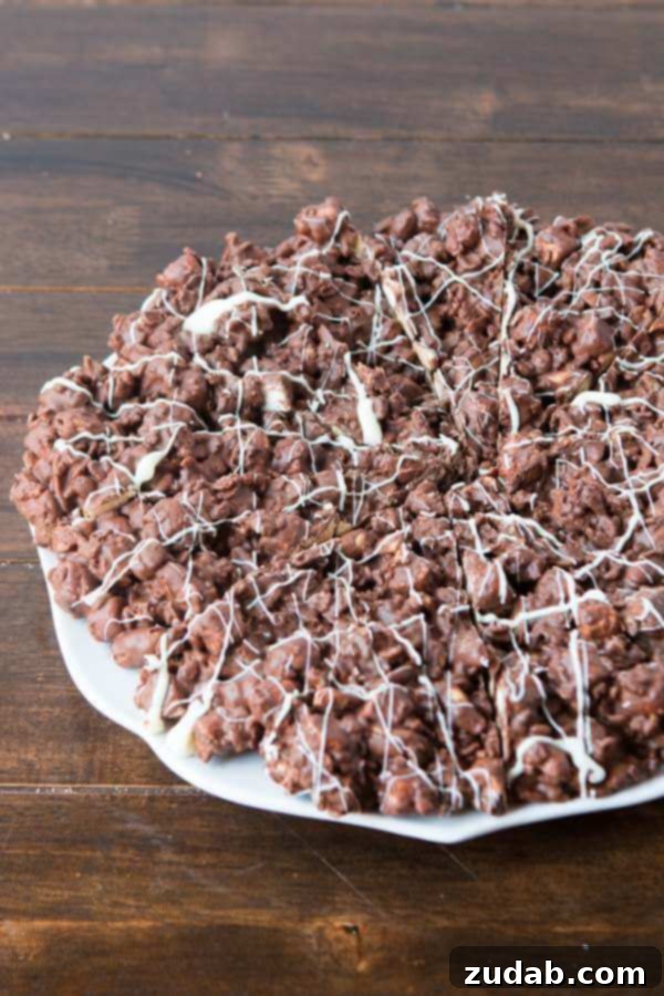 Close-up of a delicious slice of Rocky Road Chocolate Pizza with marshmallows, nuts, and chocolate Close-up of a delicious slice of Rocky Road Chocolate Pizza with marshmallows, nuts, and chocolate