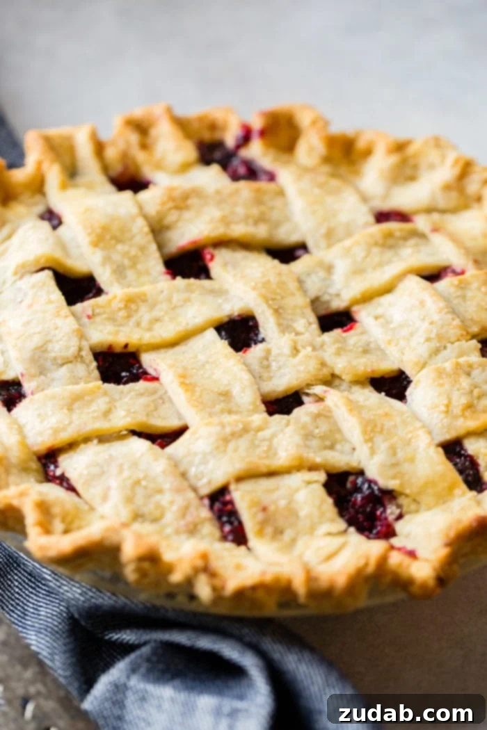 The Ultimate Razzleberry Pie 3 Close-up of fresh raspberries, blueberries, and blackberries, the key ingredients in razzleberry pie.