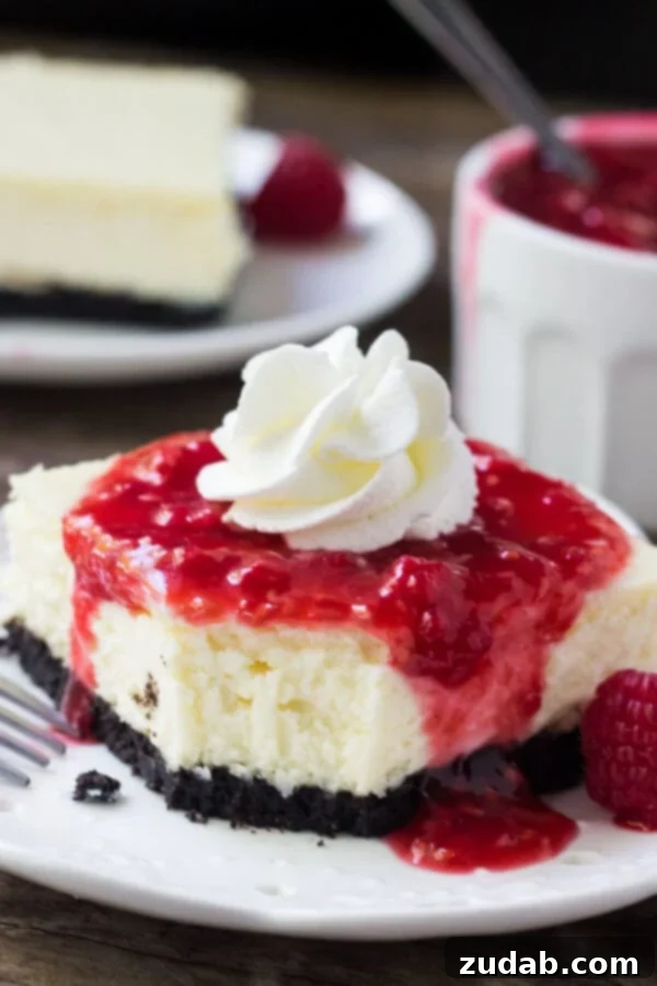 Creamy, smooth white chocolate cheesecake with an Oreo cookie crust. If you're looking for your new favorite dessert - then these white chocolate cheesecake bars with raspberry sauce are just the thing!