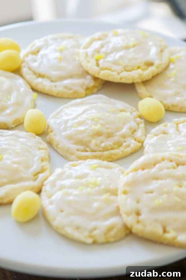 Golden Lemon Drop Cookies, Ready for Glaze Freshly baked lemon drop cookies cooling on a wire rack before glazing.