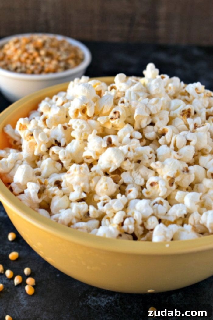 Tangy Salt and Vinegar Popcorn 3 A close up of a big yellow bowl of Salt & Vinegar Popcorn, showing the flavorful seasoning clinging to each kernel. This salty and tangy popcorn is a fantastic late-night snack.