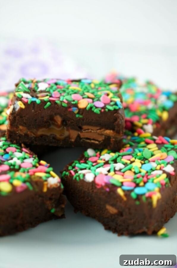 Hoppy Easter Nest Treats 7 Fudgy Caramel Egg Brownies are a decadent brownie loaded with caramel filled eggs and topped with dark chocolate ganache. A rich Easter dessert.