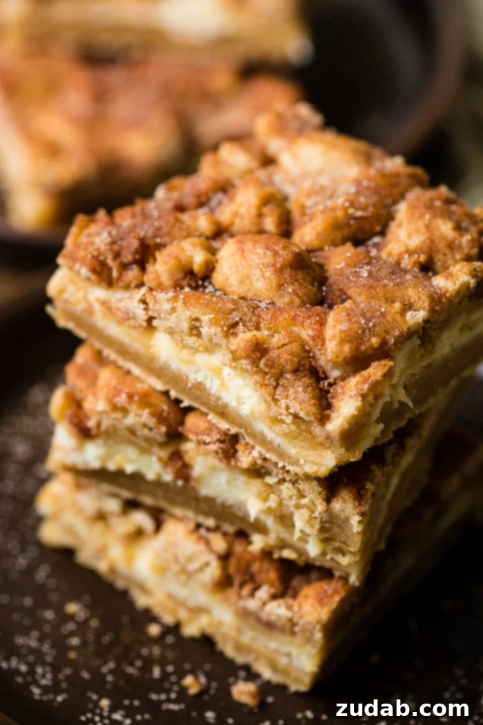 Cinnamon Dream Cheesecake Bars 3 three snickerdoodle cheesecake bars stacked on top of each other