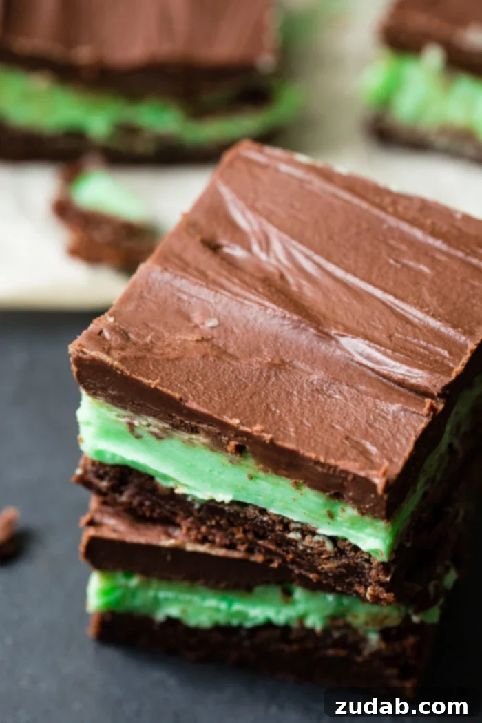BYU Mint Brownies: The Homemade Version 4 A black board with beautifully arranged brownies, each topped with a delicate mint frosting and a rich chocolate ganache. Our homemade copycat BYU mint brownies from scratch are ready to be served.