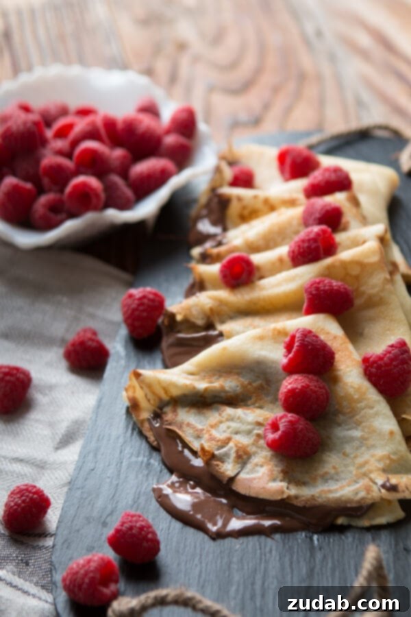Stack of freshly made Nutella Crepes with berries, ready to serve