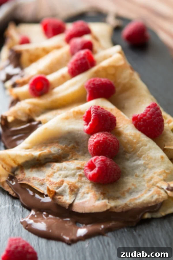Perfectly folded Nutella Crepes with a scattering of hazelnuts and chocolate shavings