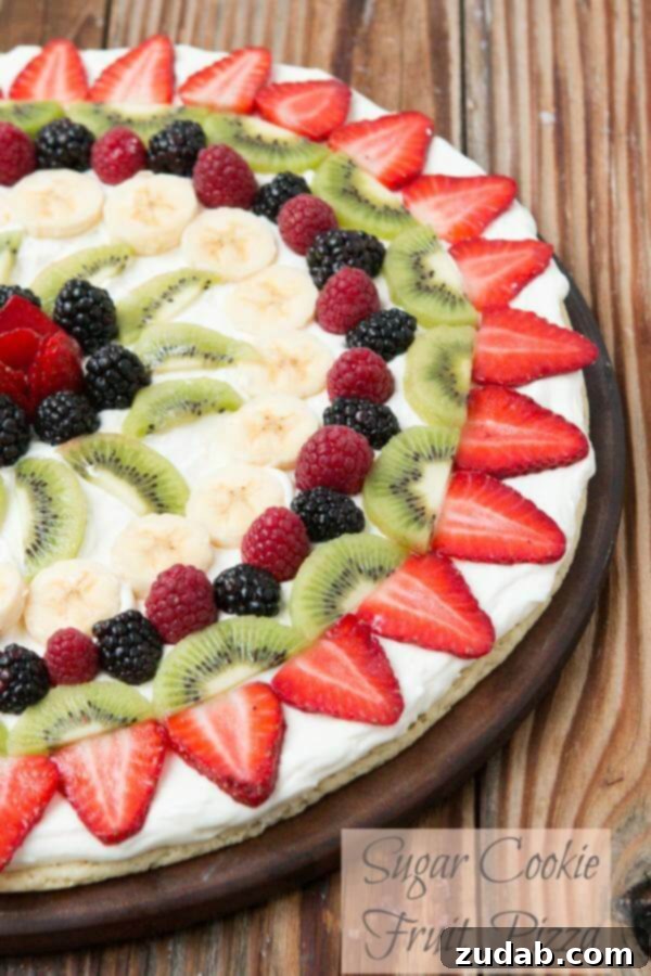 Fruit pizza with a soft sugar cookie crust ohsweetbasil.com Fruit pizza, the quick way A beautifully arranged quick fruit pizza with a soft sugar cookie crust and creamy white topping, decorated with fresh strawberries, blueberries, and kiwi slices.