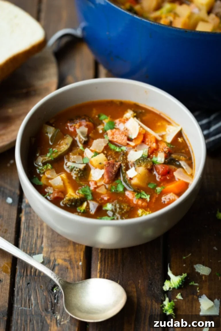 Weight Watchers Ham and Vegetable Soup Tutorial 3 a photo of a bowl of hearty ham and vegetable soup sitting on a wooden table