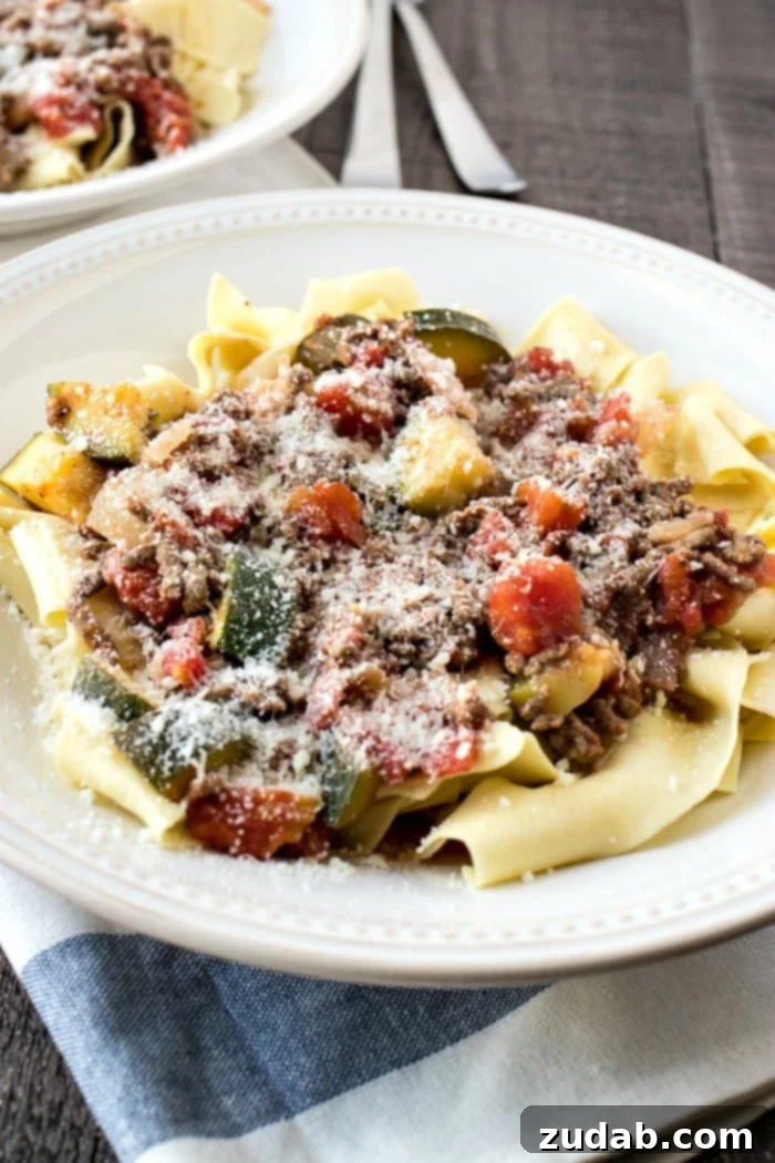 Simple & Satisfying Beef Ragu Pasta 2 A bowl of easy beef ragu and pasta with grated parmesan cheese as garnish, ready to be served for dinner.