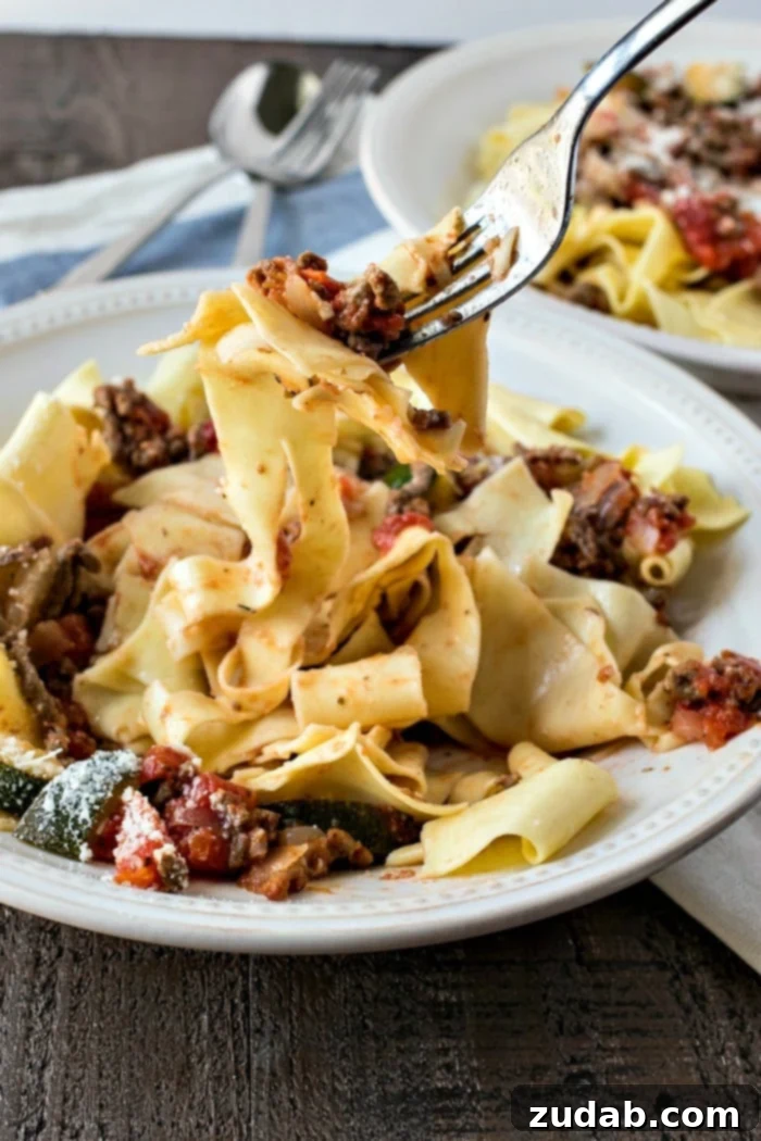 Simple & Satisfying Beef Ragu Pasta 8 Cooked pappardelle pasta tossed with savory beef ragu and garnished with fresh herbs, ready to be served.