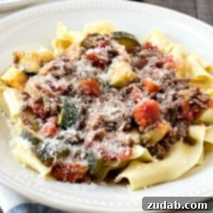 Simple & Satisfying Beef Ragu Pasta 10 A beautifully presented bowl of Easy Beef Ragu & Pasta, garnished with fresh herbs and grated Parmesan cheese, ready to be enjoyed.
