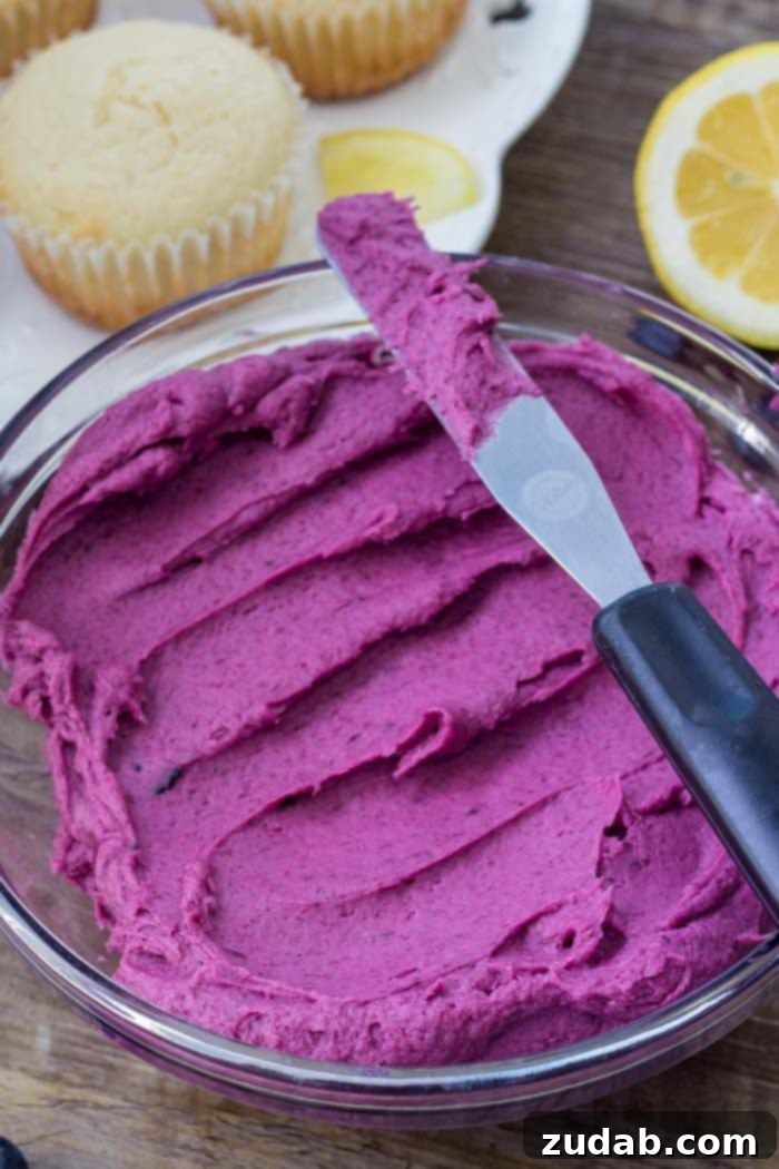 Zesty Lemon Blueberry Cupcakes 4 A bowl of fluffy blueberry frosting for lemon cupcakes