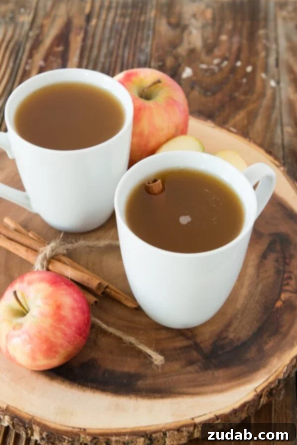 Delicious non-alcoholic wassail with orange and apple slices and cinnamon sticks