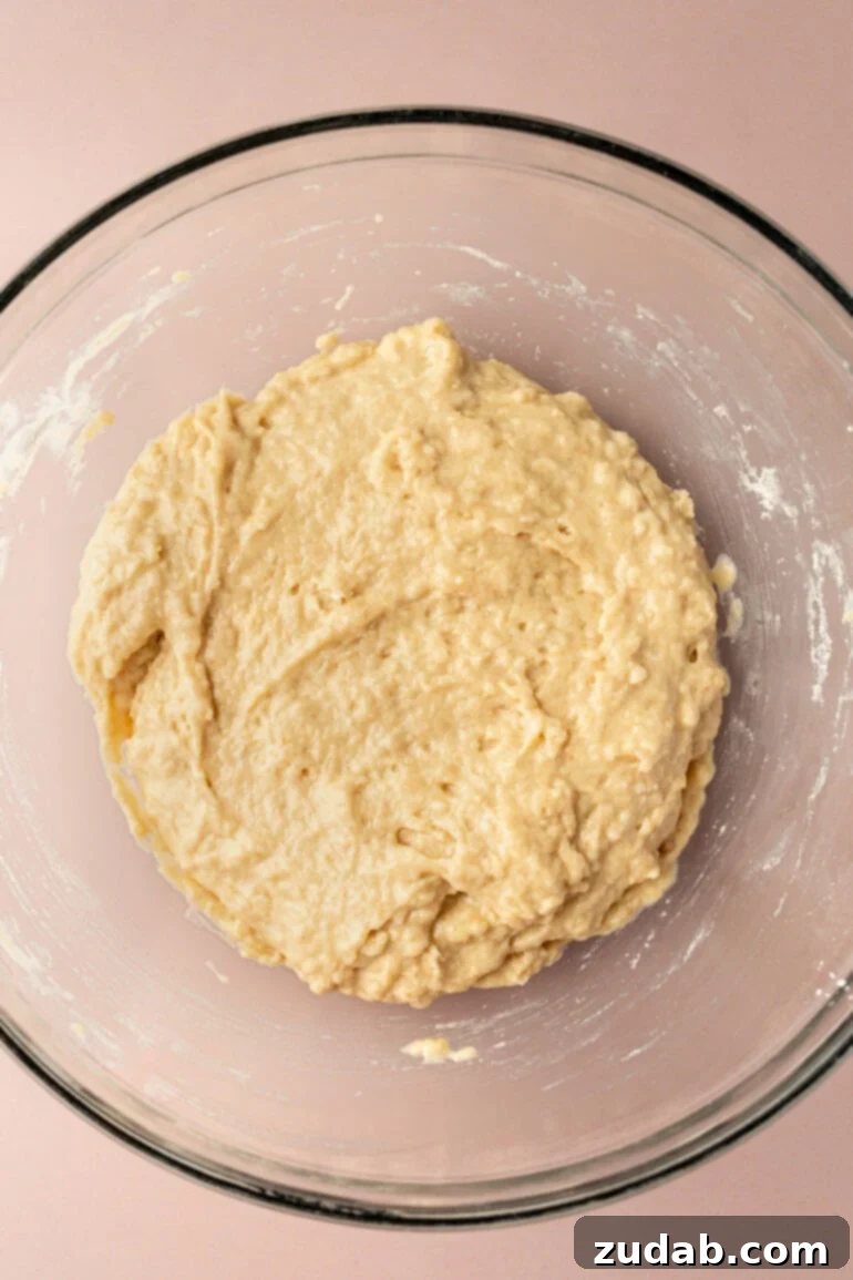 Bakery-Style Chocolate Chip Muffins 6 Wet ingredients for muffins being stirred in a separate bowl.