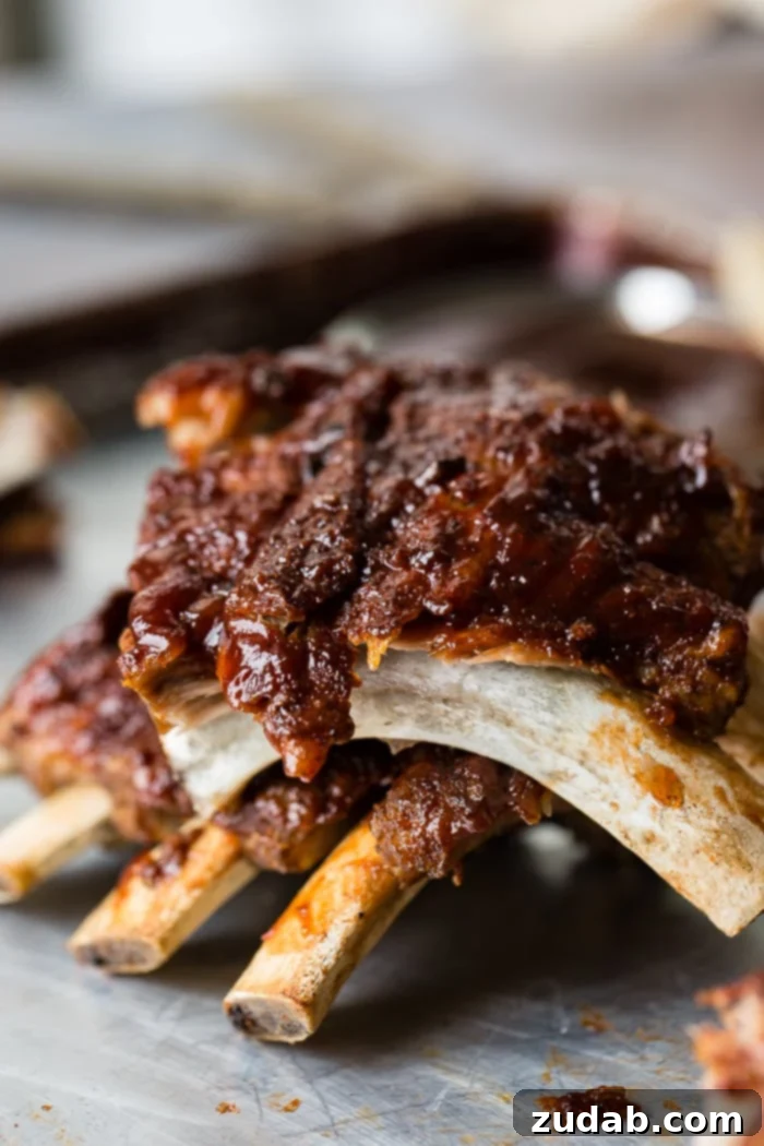 Fall-Off-The-Bone Instant Pot BBQ Ribs 4 A full rack of Smoky BBQ Instant Pot Ribs, glistening with barbecue sauce, ready for serving after achieving perfect fall-off-the-bone tenderness in the Instant Pot and a quick broil.