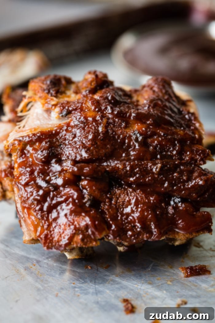 Fall-Off-The-Bone Instant Pot BBQ Ribs 5 A close-up of a stack of Smoky BBQ Instant Pot Ribs, perfectly glazed and ready to be devoured, with clear evidence of their incredible tenderness.
