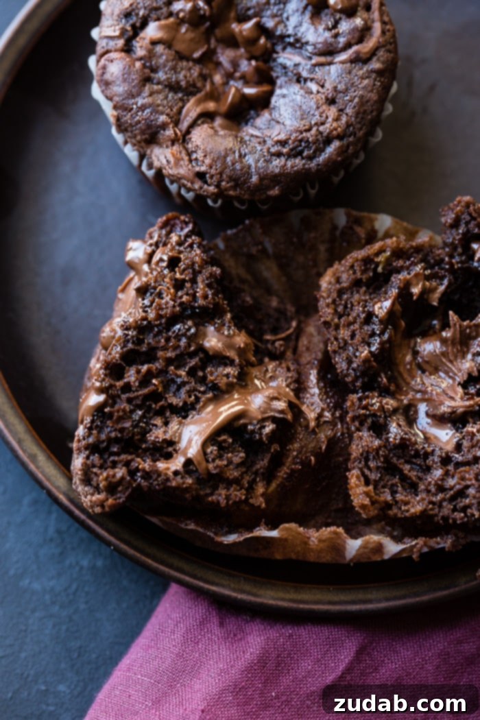 Molten Nutella Double Chocolate Banana Muffins 6 A top-down view of several Nutella-stuffed chocolate banana muffins, showcasing their rich color and texture.