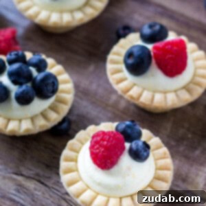 Mini fruit tarts with fresh berries and sweet vanilla filling.