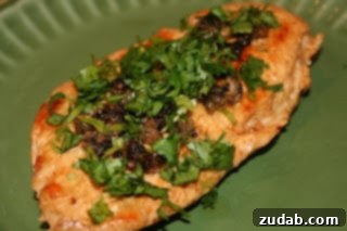 Vibrant Lemon Caper Chicken 2 Delicious Chicken Piccata served with sauce and garnished with parsley.