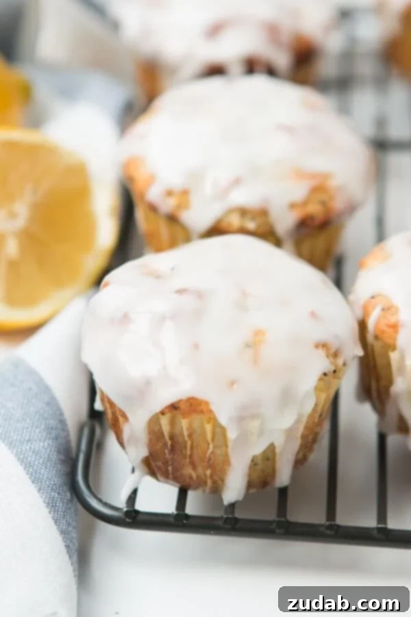 Glazed Lemon Poppy Seed Muffin Detail Close-up of a glazed lemon poppy seed muffin, showing the delicate glaze and the texture of the muffin.
