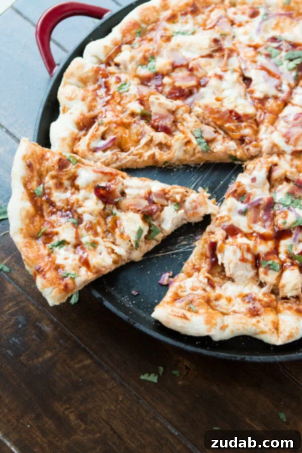 The Secret Ingredient: Fresh Cilantro on Our BBQ Chicken Bacon Pizza Delicious Copycat California Pizza Kitchen BBQ Chicken Bacon Pizza, garnished with fresh cilantro, hot and ready to serve.
