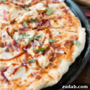 Restaurant-Quality BBQ Chicken Bacon Pizza 2 A delicious slice of Copycat California Pizza Kitchen BBQ Chicken Bacon Pizza, ready to be served.