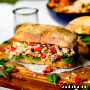 A vibrant roasted red pepper chicken salad with balsamic dressing, served in a bowl, ready to be enjoyed.