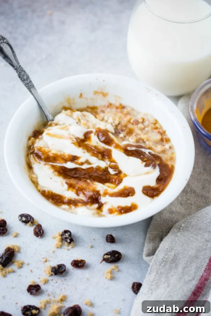 Guilt-Free Cinnamon Swirl Oats 2 A beautifully garnished bowl of lightened up cinnamon roll oatmeal, drizzled with a cinnamon filling and a creamy glaze, with scattered brown sugar, cinnamon, and plump raisins