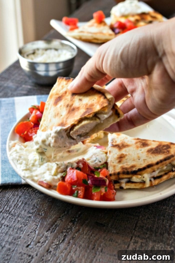 Mediterranean Mezze Skewers 9 Savory Greek Chicken Quesadillas with melted cheese and seasoned chicken, served with a fresh tomato salad and tzatziki sauce.