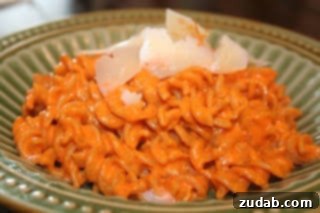 A beautifully plated dish of Roasted Red Pepper Pasta, ready to be served.