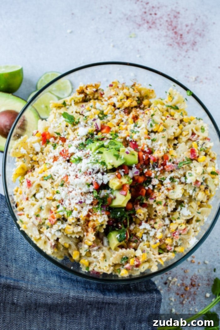 Mexican Street Corn Pasta Salad 4 photo of a bow tie pasta salad with avocados, peppers, grilled corn, cilantro, and cotija cheese making up an Elote Mexican Corn Pasta Salad