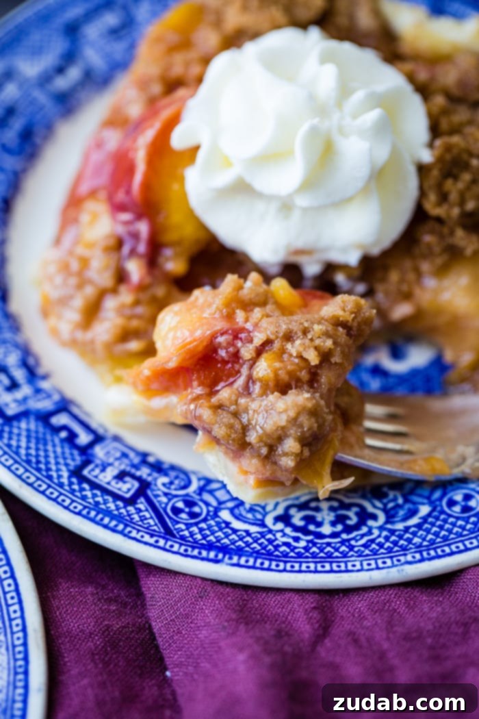 A beautifully composed flat lay of a slice of brown sugar peach pie bar, a sprig of basil, and fresh peaches, suggesting a fresh, homemade, and delightful dessert.