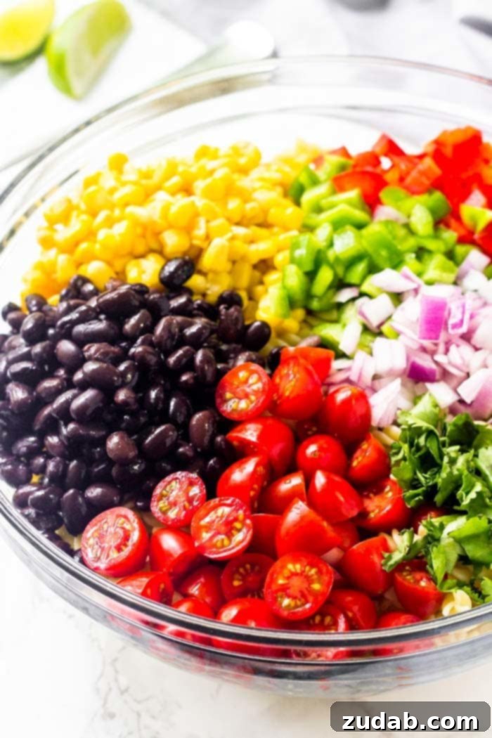 Fiesta Southwest Pasta Salad 4 Freshly chopped tomatoes, black beans, corn, bell peppers, red onion, and vibrant cilantro, ready to be tossed into a delicious Southwest pasta salad.
