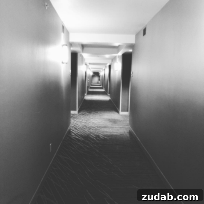 Angels Can Be Seen 2 A dimly lit hotel hallway, evoking a sense of quiet suspense and introspection.