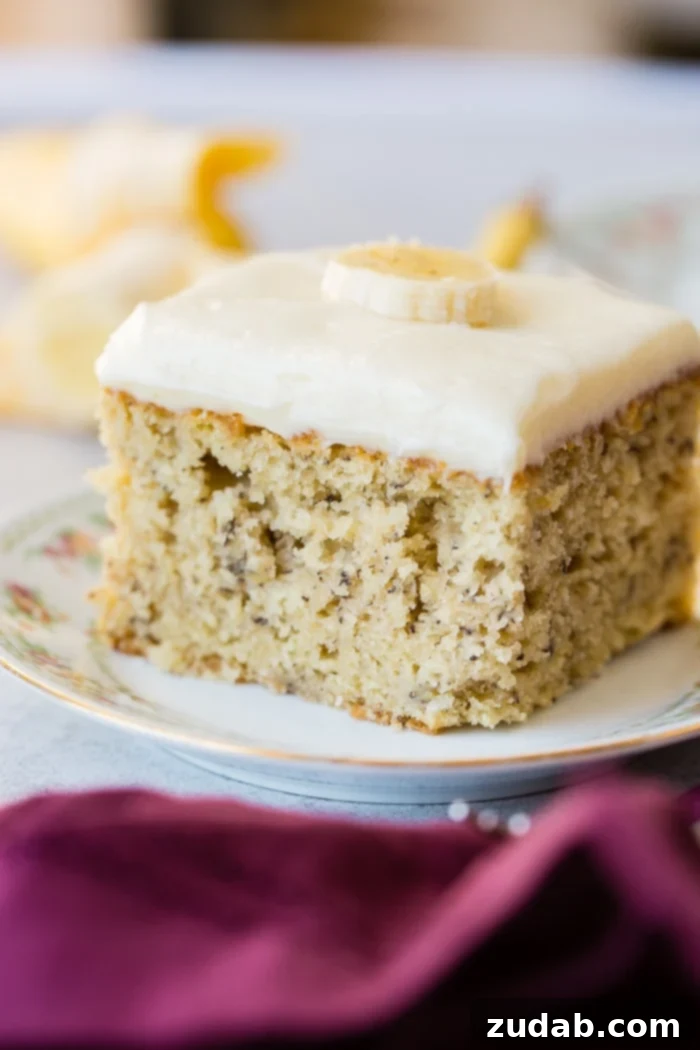 Perfectly Moist Banana Cake 4 Another enticing close-up of a banana cake slice with cream cheese frosting, emphasizing its rich texture and perfect topping.
