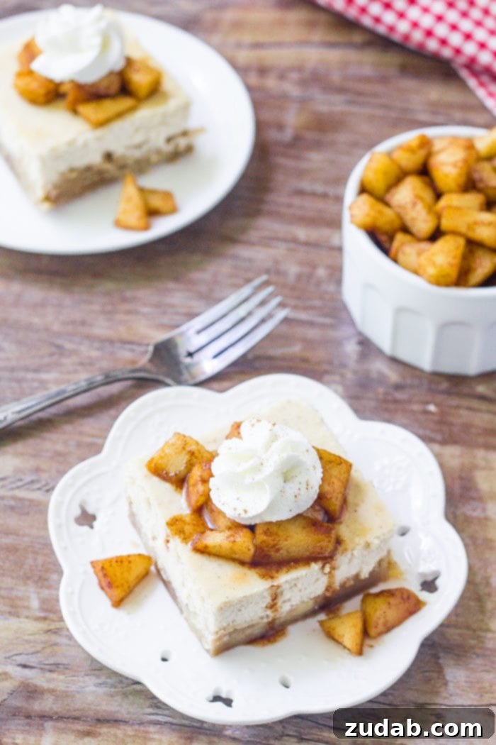 Autumn Apple Cheesecake Squares 4 A slice of apple cheesecake bars topped with cinnamon sugar apples and whipped cream